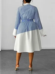 Back view of a stylish blue and white striped patchwork polo collar midi dress