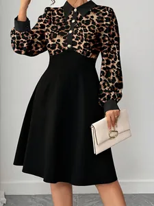 Close-up detail of leopard print midi dress featuring a black POLO collar and gold buttons
