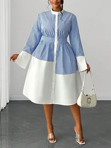 Elegant blue and white striped patchwork dress with stand collar and wide cuffs.