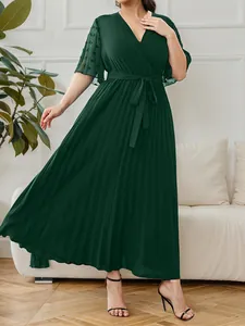Elegant dark green V-neck pleated maxi dress featuring sheer mesh flutter sleeves