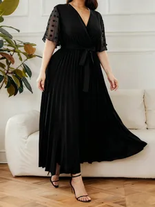 Detail view of plus size black V-neck pleated dress with sheer polka dot sleeves
