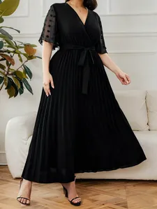 Elegant black V-neck pleated plus size dress with sheer polka dot mesh sleeves