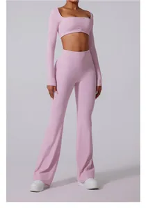 Close-up of pink high-waisted flared yoga pants and matching long-sleeve crop top