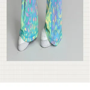 Detailaufnahme einer bunten Yoga-Schlaghose mit Leopardenmuster und weißen Sneakers