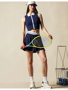 Full-length view of navy blue tennis set with zip-up top and pleated skirt.