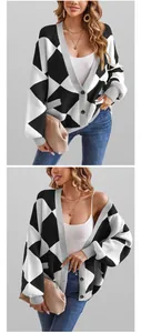 Detail view of black and white argyle knit cardigan with gray ribbed trim