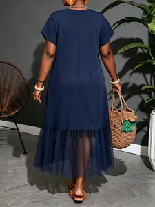Back view of navy blue midi dress featuring sheer mesh ruffle hemline details