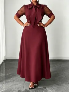 Elegant burgundy midi dress featuring mesh sleeves and a stylish bow tie neck detail