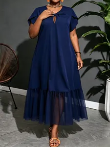 Detailed view of the navy blue plus size dress featuring mesh patchwork hem