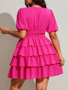 Back view of a vibrant fuchsia tiered mini dress with puff sleeves for summer fashion.
