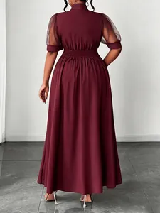 Back view of elegant burgundy plus size midi dress featuring mesh patchwork sleeves and high waist