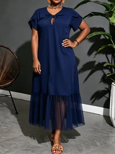 Detailed view of navy blue plus size dress featuring a sheer mesh panel hem.