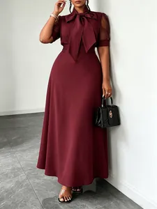 Elegant burgundy midi dress featuring a bow-tie neck and sheer mesh patchwork sleeves