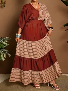 Detail of a V-neck tiered maxi dress with terracotta color block and beige stripes.
