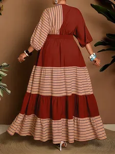 Back view of bohemian tiered maxi dress featuring striped color-block design and layers