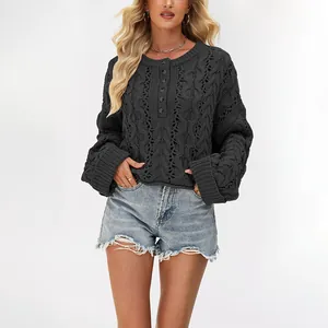 Women's charcoal cable knit button-up pullover sweater paired with denim shorts