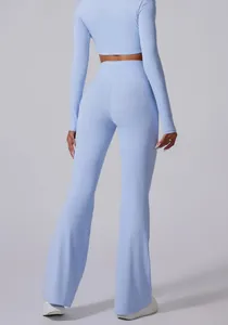 Back view of light blue high-waisted flared yoga pants showcasing body-sculpting fit