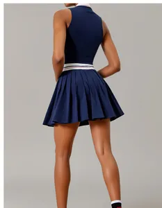 Back view of navy blue tennis set with breathable mesh top and striped pleated skirt