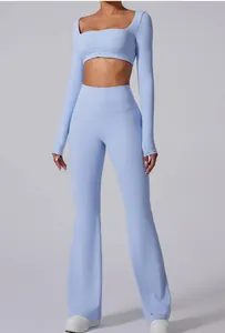 Light blue long sleeve crop top and high waisted flared yoga pants set for women.