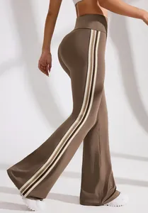 Side view detail of brown high-waisted flared yoga pants featuring stylish side stripes.