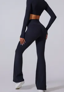 Back view of high-waisted black flared yoga pants featuring body-sculpting seam details