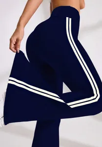 Detail of navy blue high-waisted flare yoga pants with white side stripes design