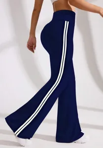 Detail view of navy flare yoga pants with white side stripes and high-waisted compression fit
