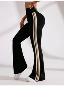 Side view of high-waist black flare yoga pants with decorative athletic side stripes