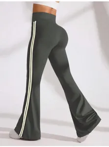 Detailed back view of high waist flared yoga pants with white side stripes for gym