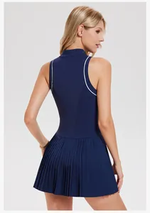 Back view of a sleeveless navy blue tennis dress featuring a pleated skirt design.