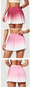 Pink gradient pleated sports skirt for tennis and yoga featuring a high waist