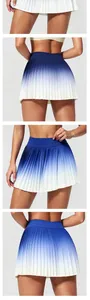 Blue gradient pleated tennis skirt with high waist for sports and fitness.