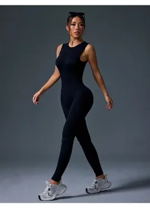 Professional studio view of a black sleeveless yoga bodysuit on an active model