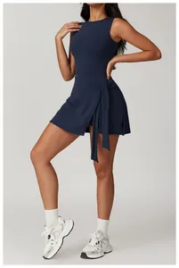 Close-up of a navy blue athletic tennis dress featuring a stylish tie-waist wrap design
