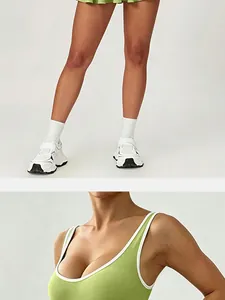 Close-up views of a lime green tennis sports dress with white piping and pleated skirt