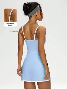 Back detail of a blue A-line tennis dress with adjustable clasp straps and white trim