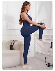 Woman in seamless navy blue yoga jumpsuit with criss-cross back and built-in bra.