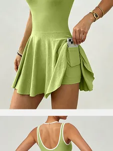 Close-up of green athletic tennis dress showing side pocket and white piping detail