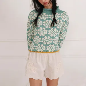 Elegant loose knitted sweater with mint green floral jacquard pattern and contrast hem