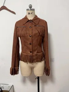 Vintage brown faux suede jacket featuring fringe tassels displayed on a mannequin.