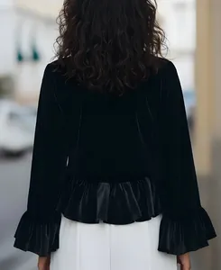 Back view of elegant French style black silk velvet top with ruffle hem and cuffs