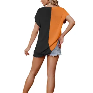 Women's oversized V-neck short sleeve knit top featuring black and orange color block