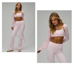 Detail view of pink ballet-style yoga set with tie-up wrap top and high-waist flared leggings