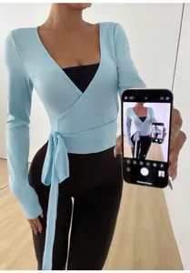 Detailed view of lightweight light blue yoga wrap top with side tie closure