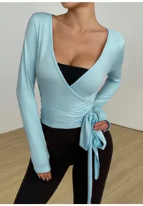 Detailed view of light blue long-sleeve wrap yoga top with side tie for fitness