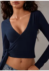 Close-up of navy blue long sleeve yoga wrap top featuring an adjustable tie-front detail