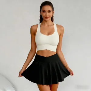 Women's high-waisted pleated athletic skort and white sports bra for yoga and golf
