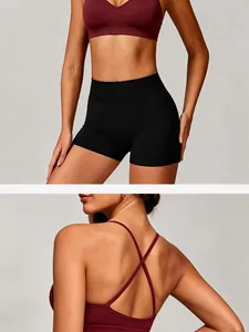 High-performance seamless wine red yoga bra with criss-cross back and black fitness shorts set