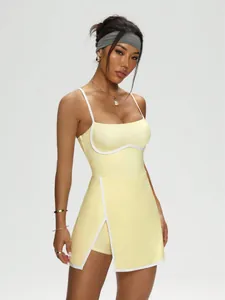 Full-body view of a yellow tennis dress with white contrast trim and built-in shorts