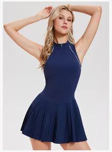 Detail view of navy blue pleated tennis dress with half-zipper and white piping